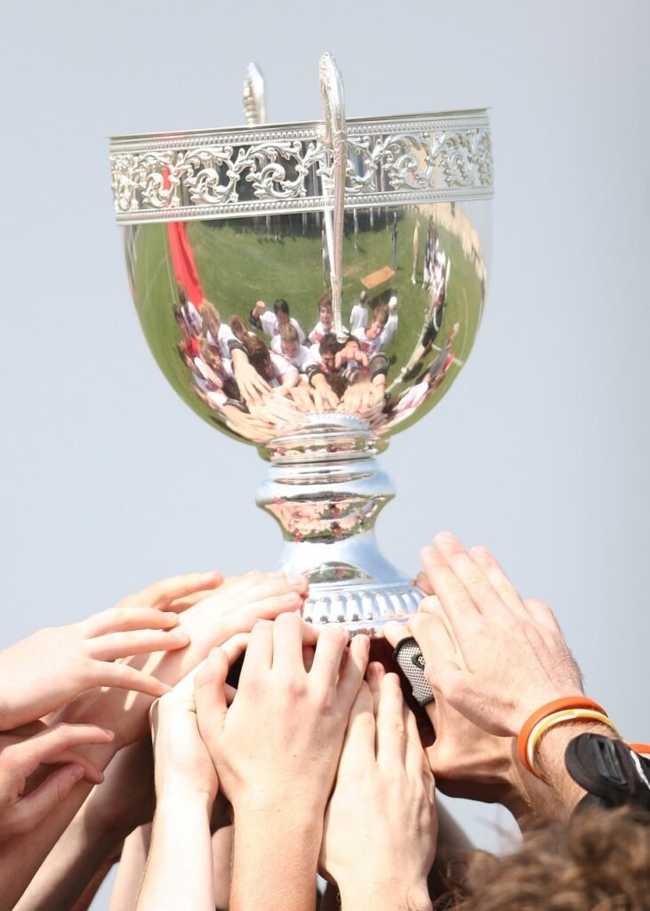 People holding the trophy cup