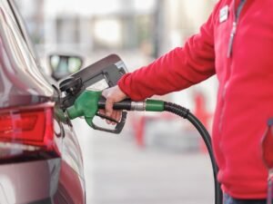 A person filling up a car petrol tank